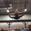 A midair straddle at a trampoline park.